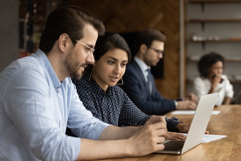 Focused,Millennial,Male,Intern,Look,At,Laptop,Screen,Listen,To