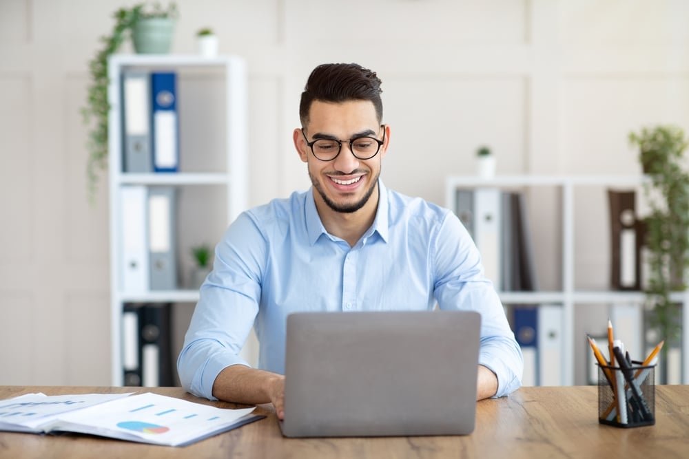 Portrait,Of,Confident,Young,Arab,Guy,Sitting,At,His,Table