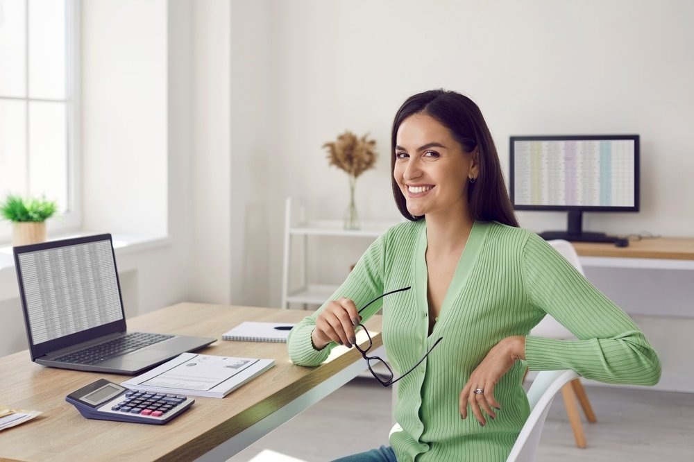 Portrait,Of,Beautiful,Happy,Female,Accountant,Sitting,At,Her,Workplace