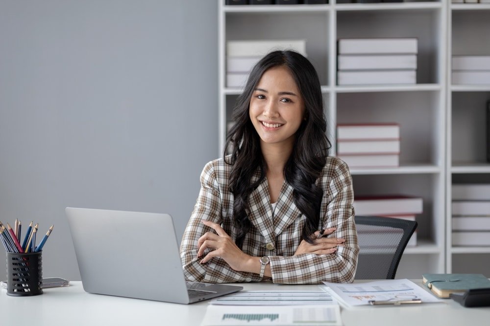 A,Beautiful,Asian,Businesswoman,Sitting,In,Her,Private,Office,,She