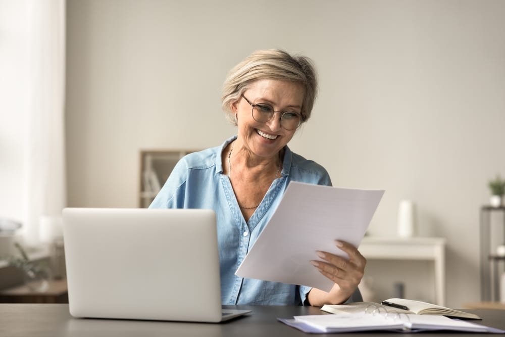 Happy,Mature,Freelance,Business,Woman,In,Glasses,Reading,Good,Terms,