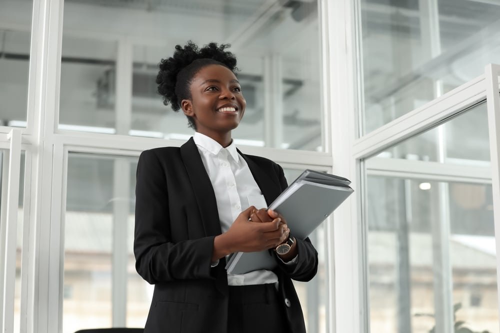 Happy,Woman,With,Folders,In,Office,,Low,Angle,View.,Lawyer,