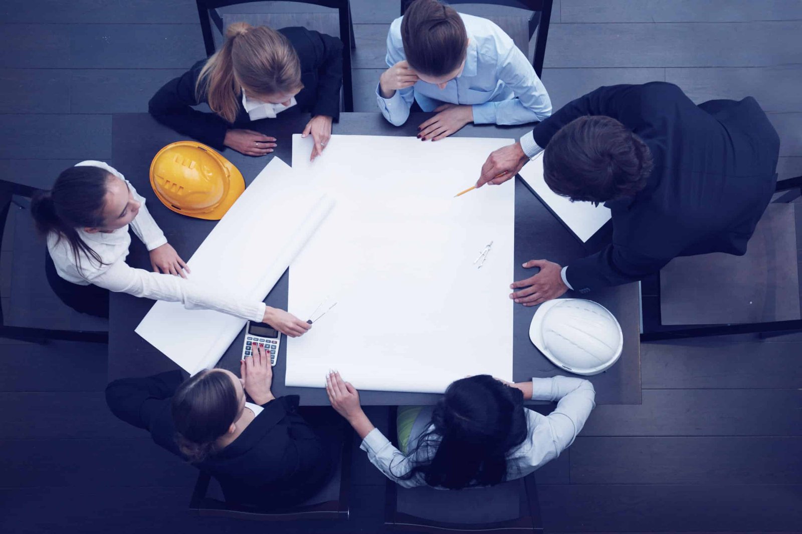 Top,View,Of,People,Around,Table,In,Construction,Business,Meeting